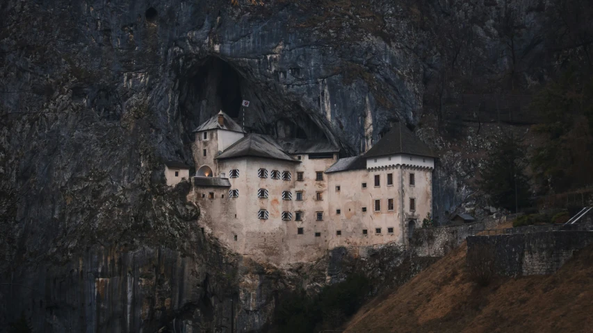 an image of a large castle built in the mountains