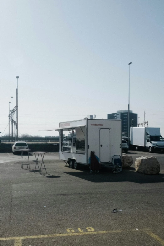 a portable kitchen sits on the ground next to cars