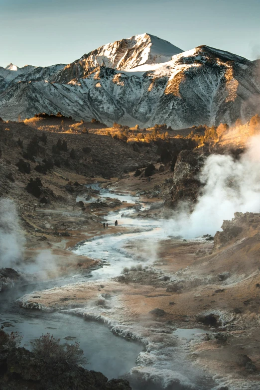 steam is coming out from the river in a valley