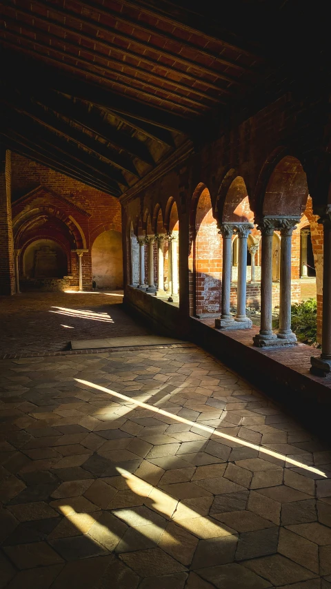 a large indoor hall with some columns and windows