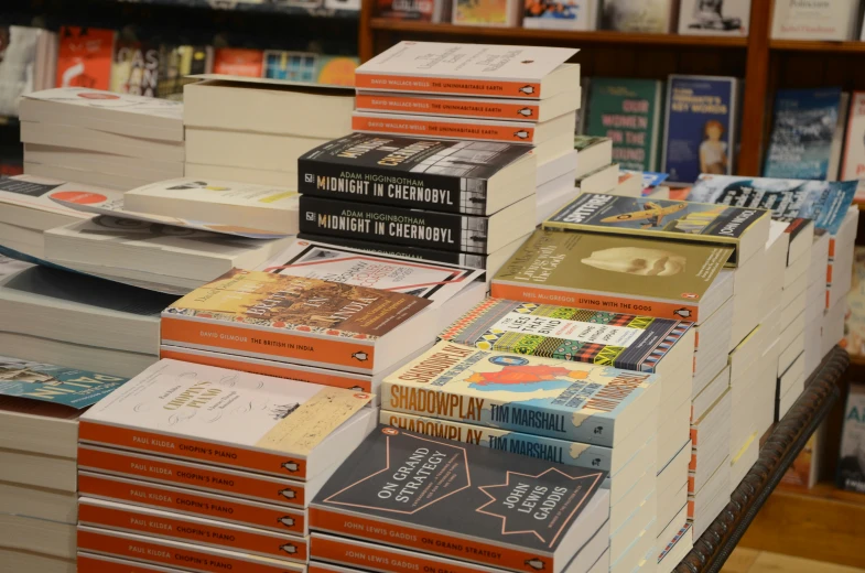 books stacked on top of each other in front of a bookstore