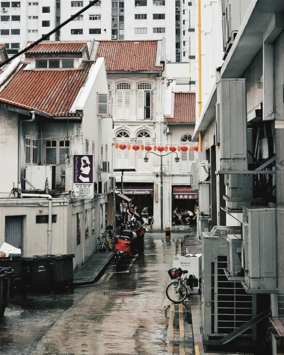 a rain soaked city street with parked bikes