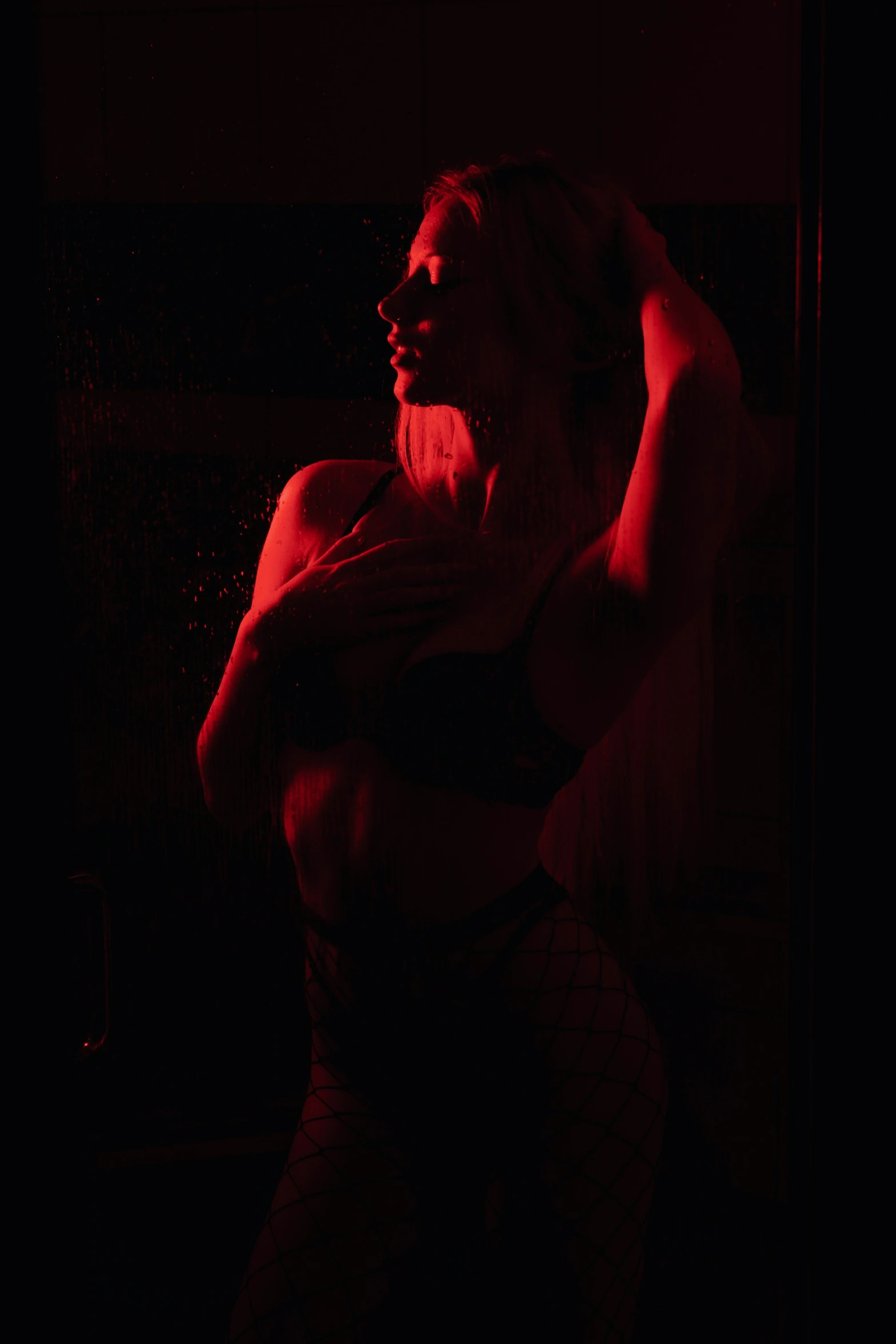 a dark picture of a women's body with the dark background