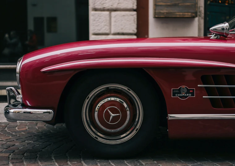 a classic mercedes benz roadster convertible parked outside