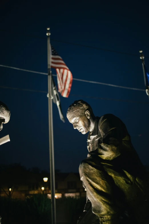 the image is of three statues in the middle of the night