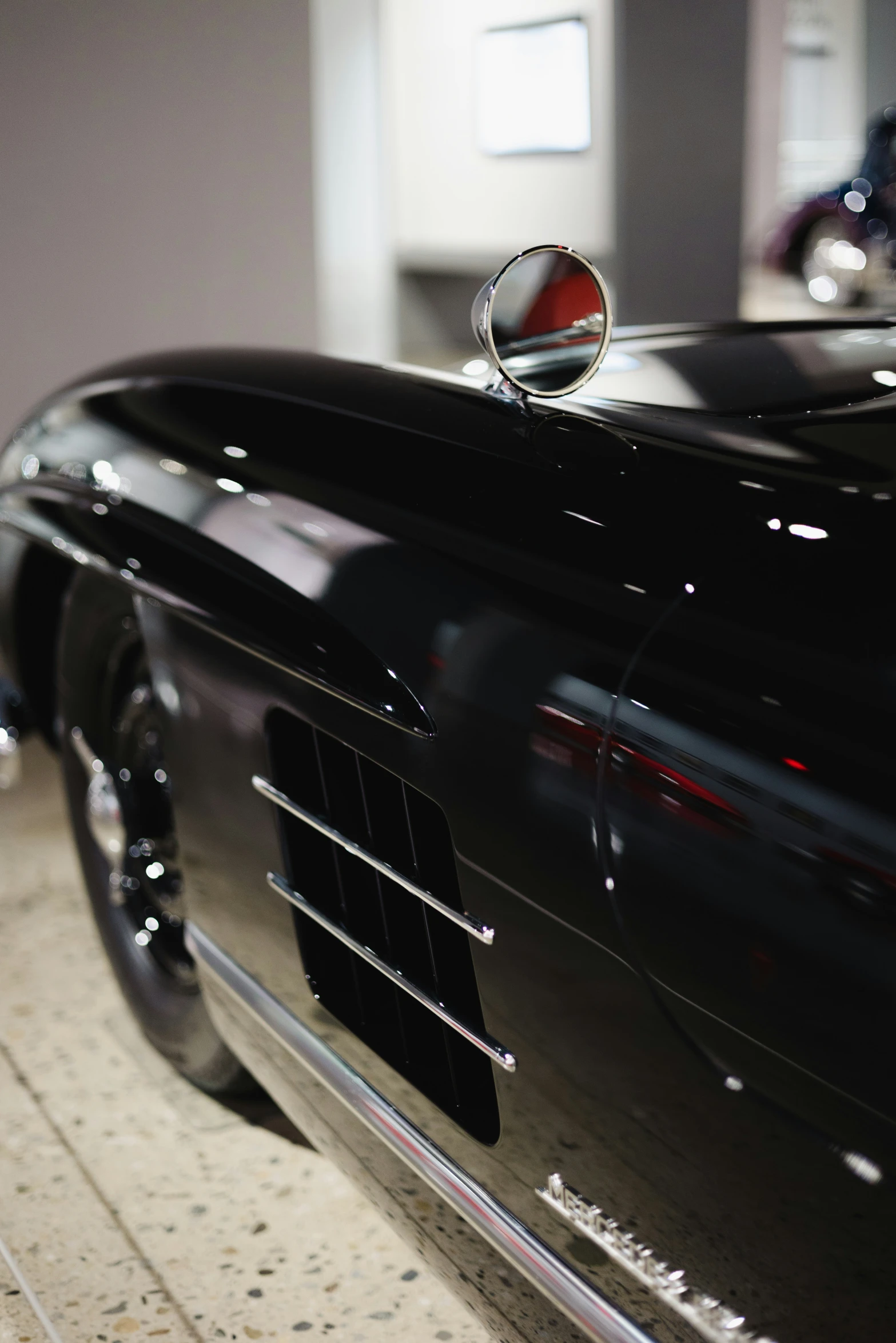 the hood of a classic sports car on display