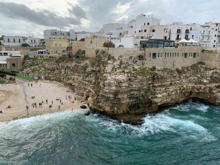 a beach with swimmers on a cloudy day