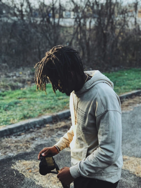 a person with dreadlocks on a skateboard