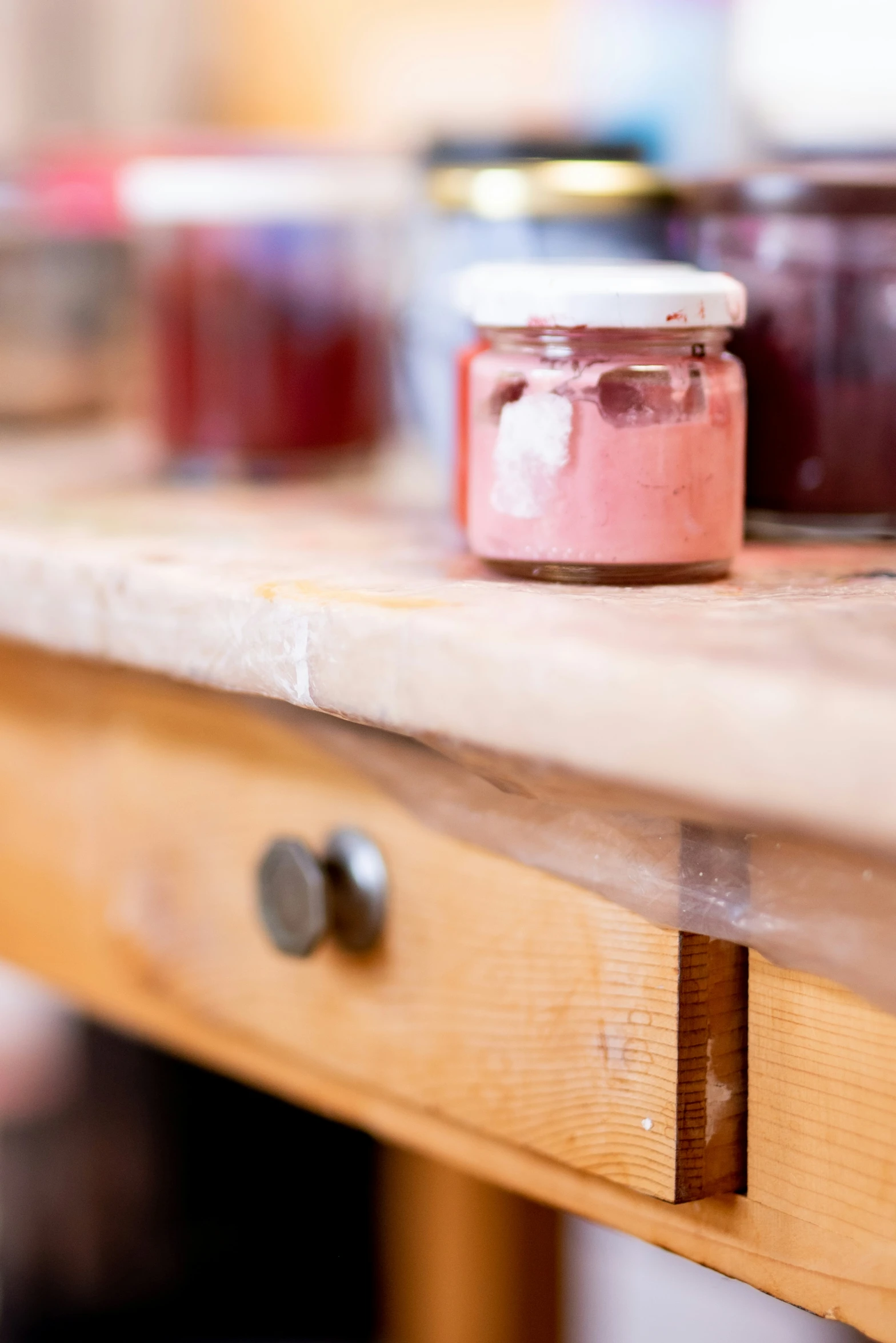 several jars on a table that are lined up