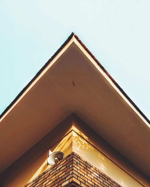 a brick wall with the roof up and light coming through