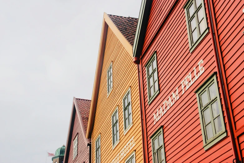 several very tall building with different colored windows