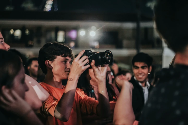 a woman taking a po of soing in a crowd