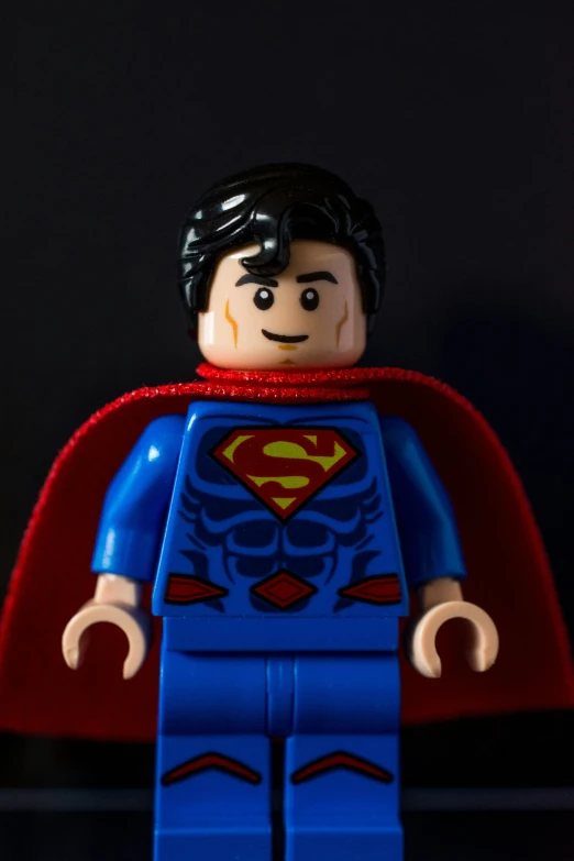 a lego figure with a red cape and cape