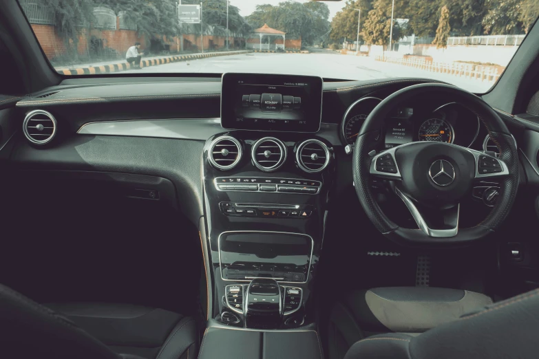 an image of dashboard and steering wheel view from the inside