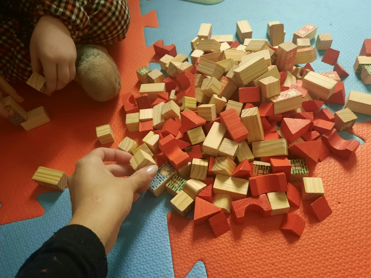 the child plays with blocks with blocks on top