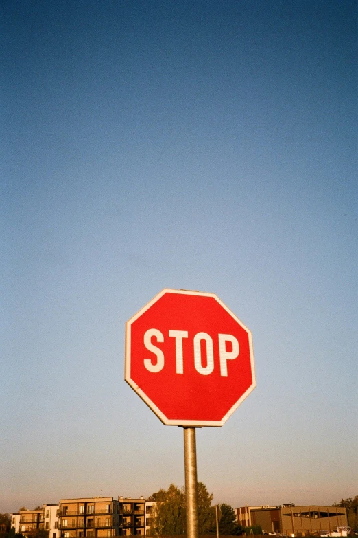 a red stop sign in the middle of an open field