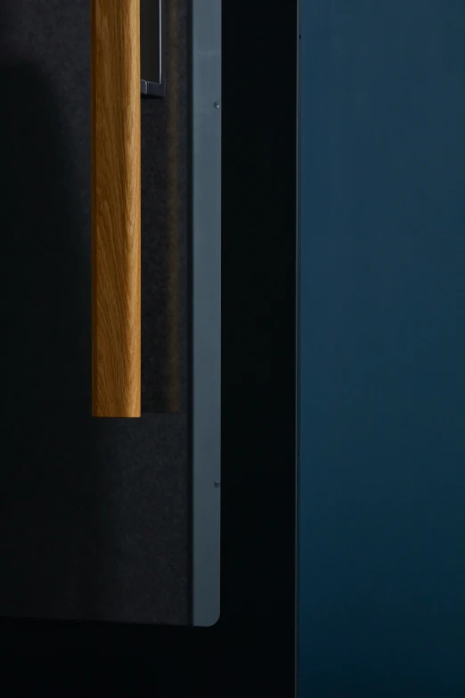 a wooden handle on the back side of a door