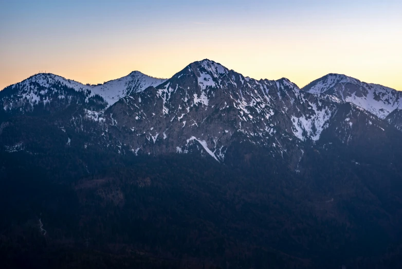 a view of some mountains covered in snow