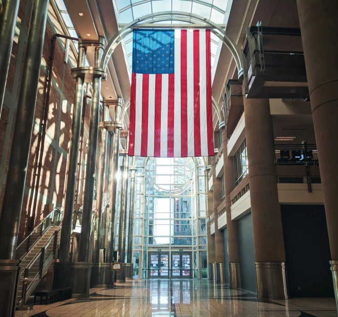 a long hallway has an american flag hanging from the ceiling