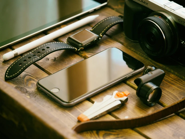 an iphone is sitting on a table next to other items