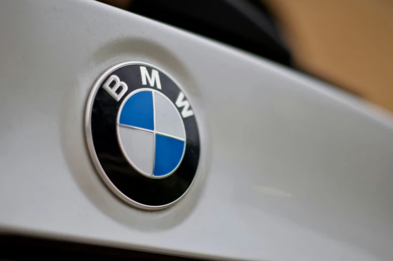 bmw emblem is on the hood of a white car