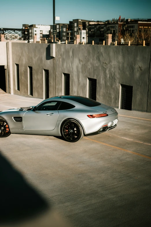 a silver sports car parked in front of a building