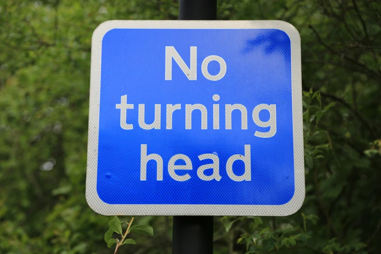 a blue and white no turning head sign