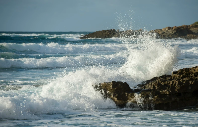 waves splash on the rocky shore in an ocean setting