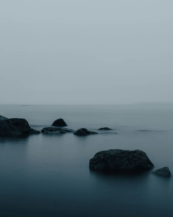 a large rock in the middle of a body of water