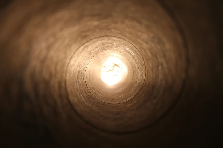 a view from up a spiral, with a white circle light above it