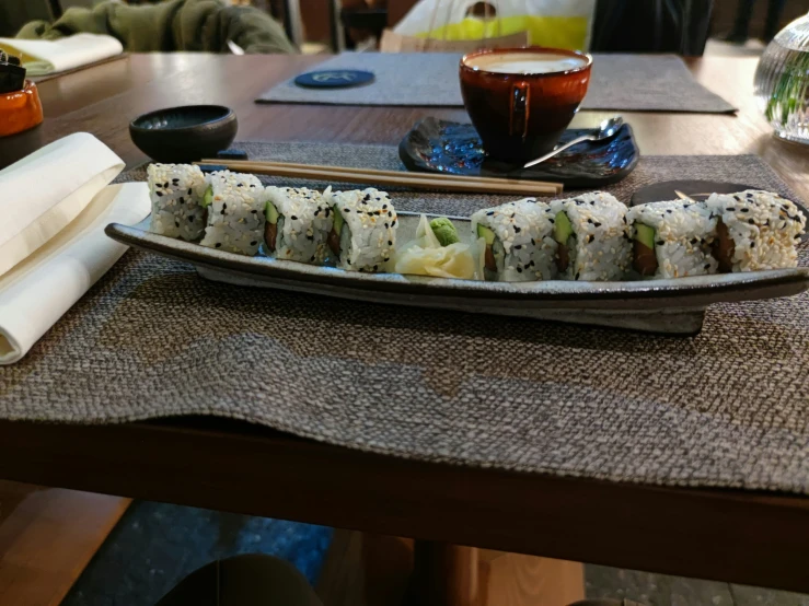 there is sushi and chopsticks sitting on the table