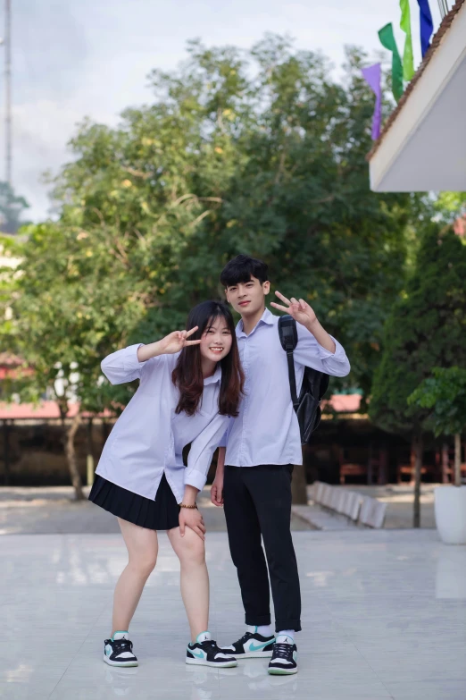 a couple poses for a picture on skate boards