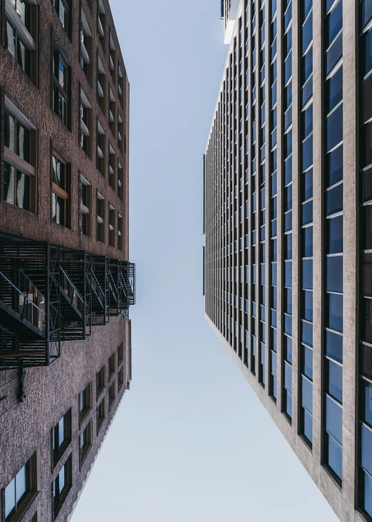 two tall buildings with windows next to each other