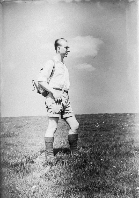 a man standing in an open field with gloves and gloves on