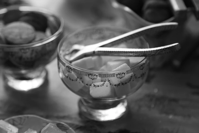 several ice cubes in cups with spoons in them