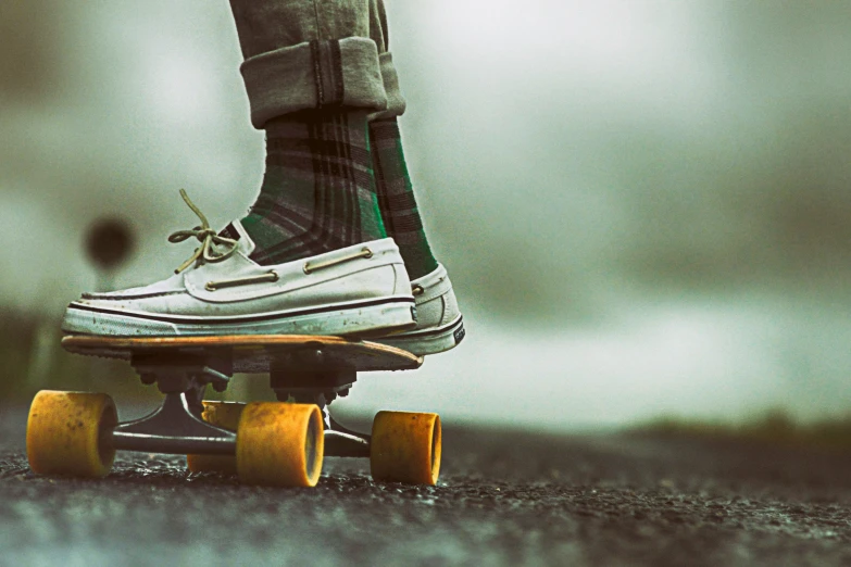a person in sneakers is riding a skateboard