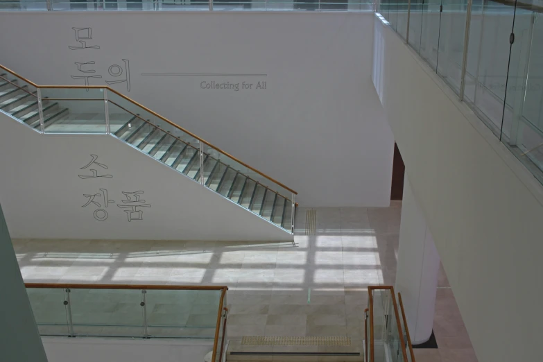 a large stairway has been converted to become an apartment with glass railings and glass balustre