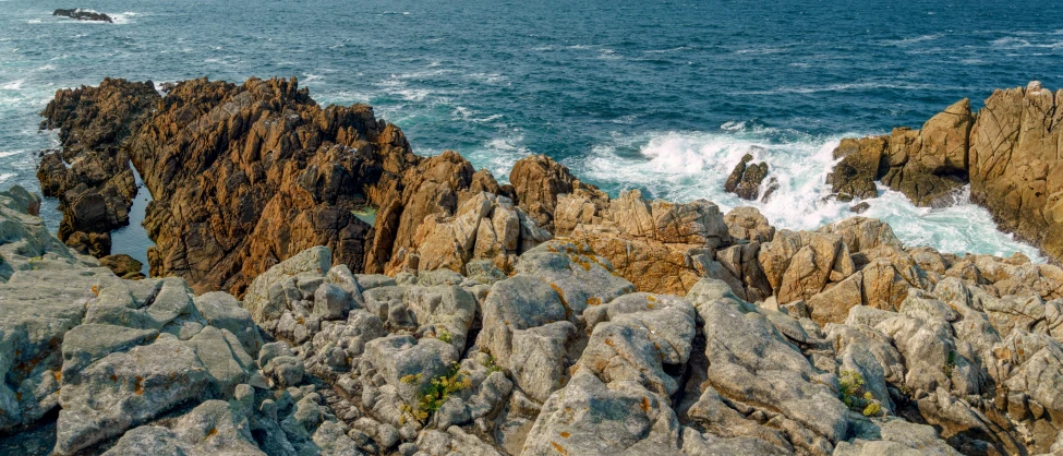 rocks at the beach have water in the middle