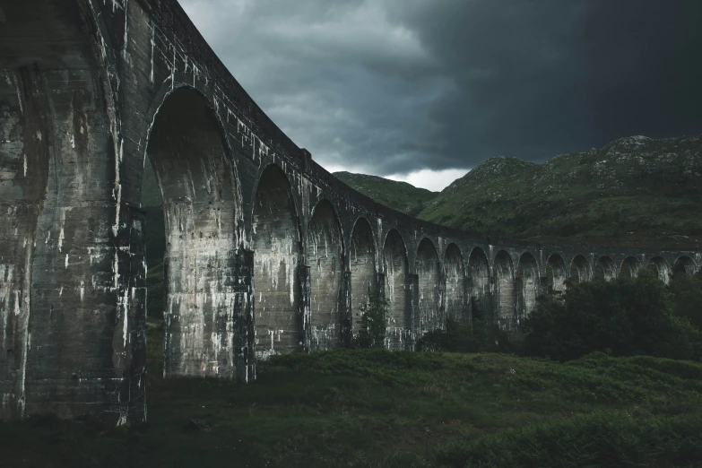 a dark and gloomy po of an old stone bridge