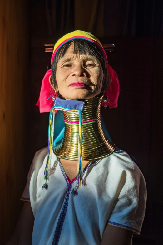a woman wearing the neck ce of an ancient tribal tribe