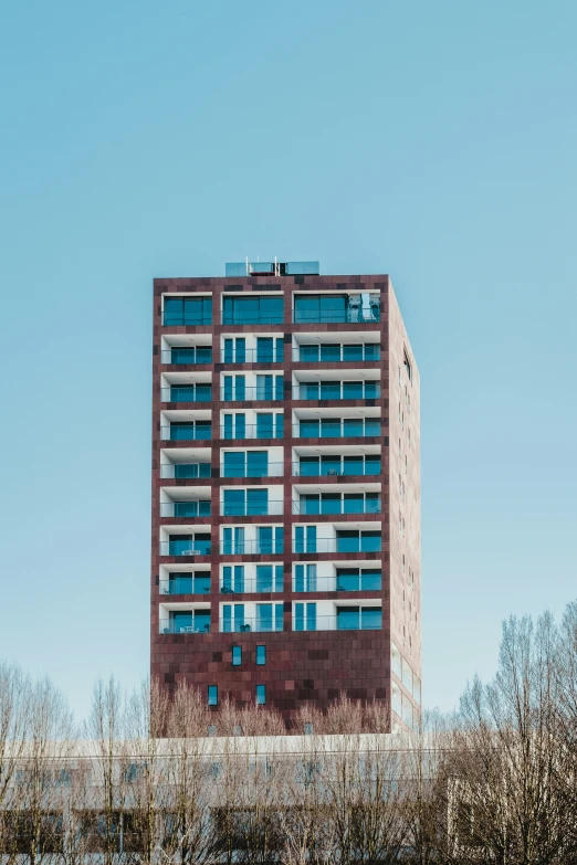 an apartment building sits in the middle of trees