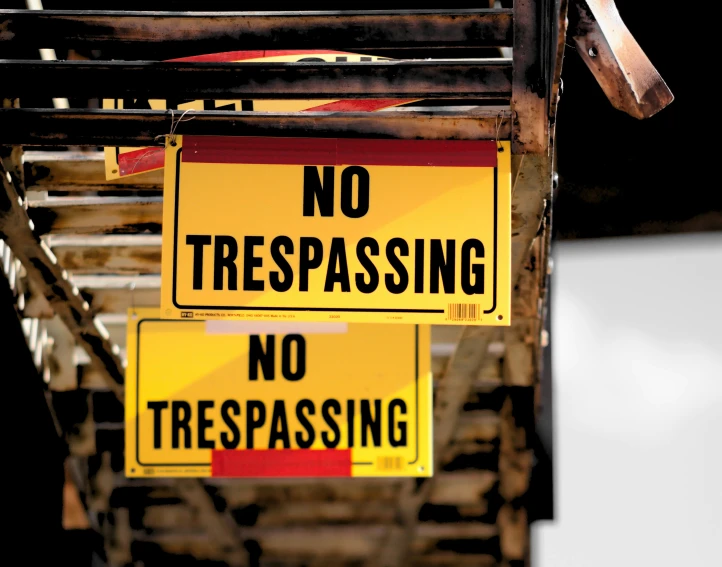 two signs showing no trespassing and no trespassing