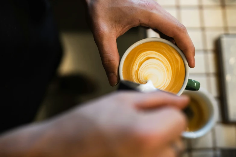 a person holding a cup of coffee