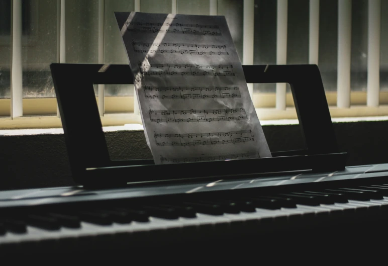 a sheet of music is sitting next to a piano keyboard