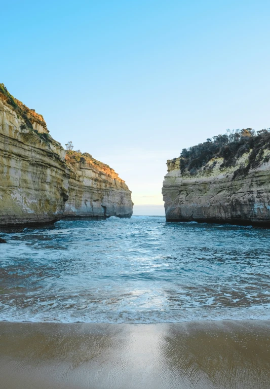 a body of water with some rocks in the distance