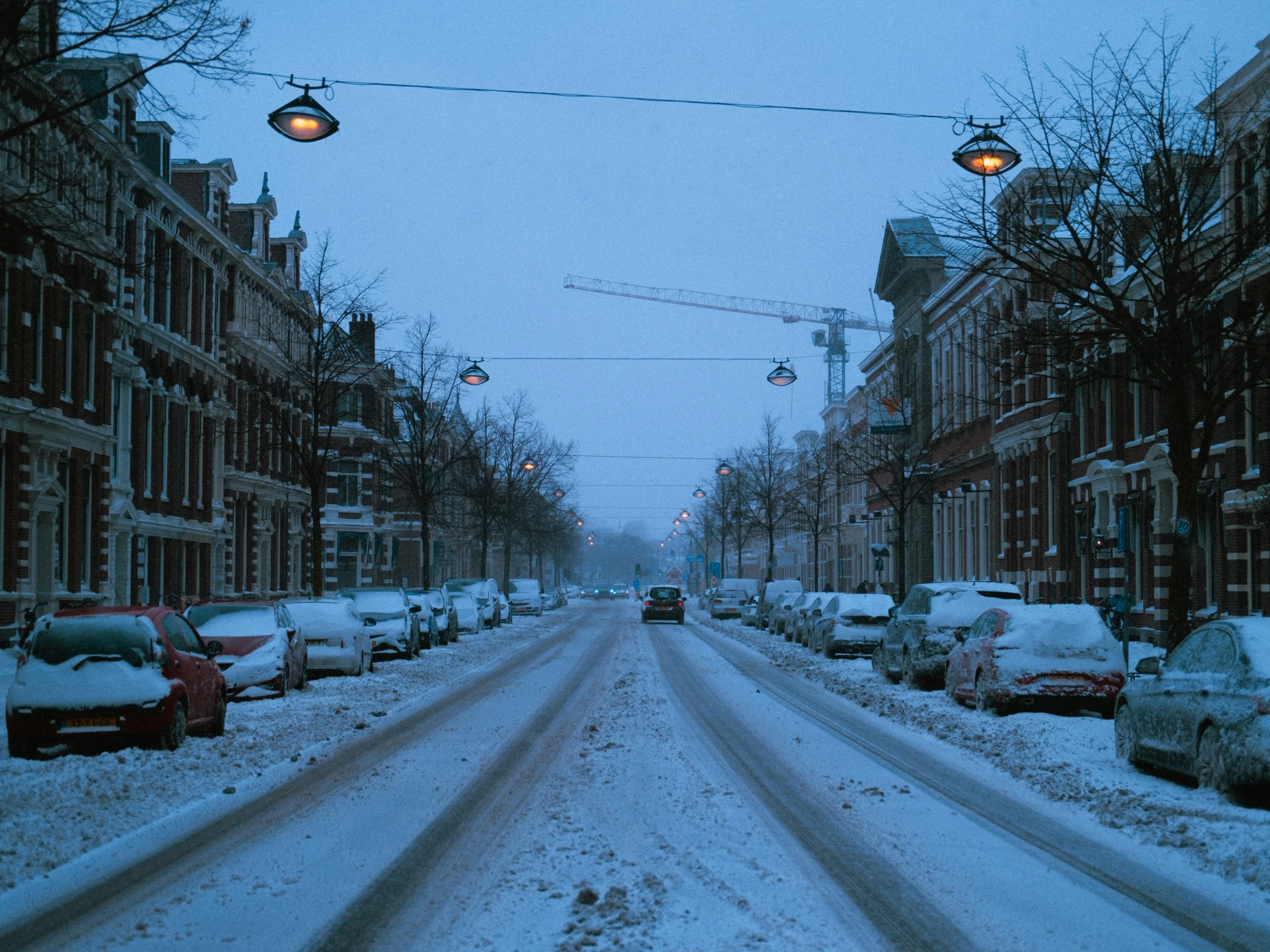 snow blankets the streets and cars in this city