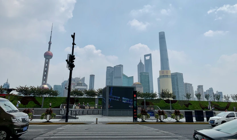 an intersection with lots of traffic and some very tall buildings