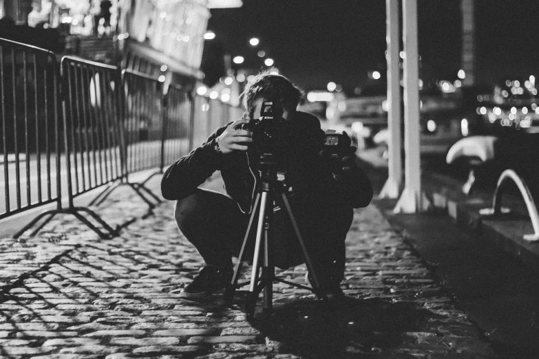 black and white pograph of a pographer with her camera