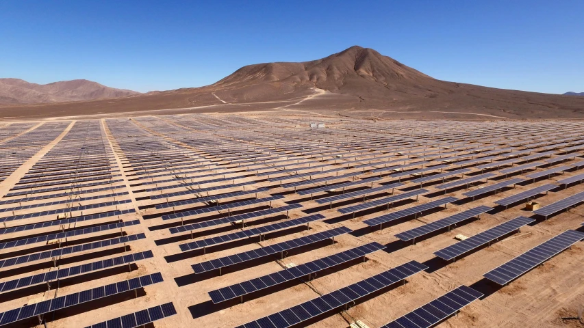 several rows of solar panels laying in the desert