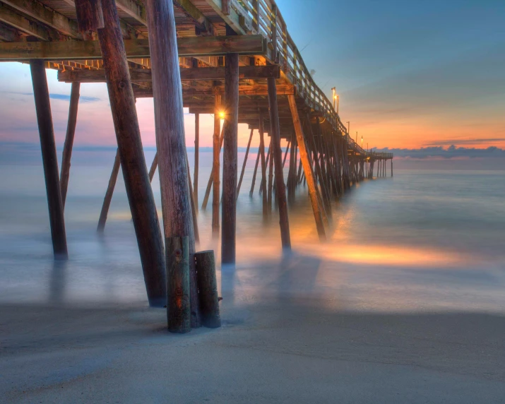 a beach under a pier that is very long